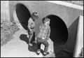 Photograph: [Boys Looking Into Tunnel Opening]