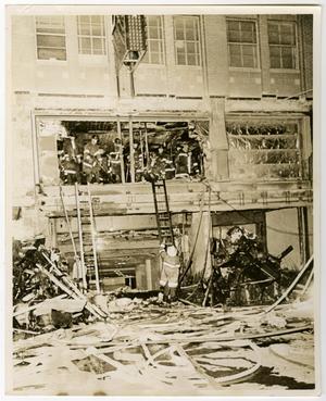 Primary view of object titled '[Firefighters Climb Into Fire-Damaged Medical Arts Building]'.