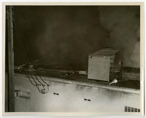 Primary view of object titled '[Smoking Roof of Superior Bowling Lanes Building]'.