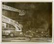 Primary view of [Firefighters Use Aerial Platform to Hose Down Building]