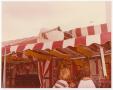 Photograph: [Broken Sky Tram Car On Top of Carnival Tent]