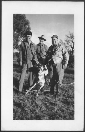 Primary view of object titled '[Three men holding a hunted pronghorn antelope at Adobe Ranch]'.