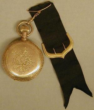[Gold pocket watch with floral engraving on both sides]
