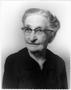 Photograph: [Mamie George wearing glasses and a black dress]