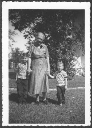 [Photograph of Mamie Davis George holding the hands of two little boys]