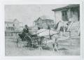 Primary view of [Photograph of Man in Wagon]
