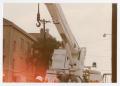 Photograph: [Public utility worker using a crane on E. Mulberry Street]