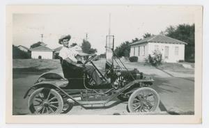 [Photograph of a Man in an Old Car]