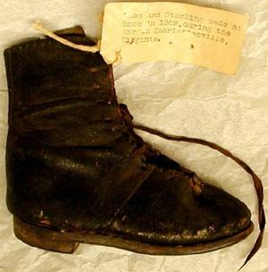 [Child's black leather lace-up boot]