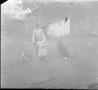 Photograph: [A young boy holding Davis George next to two dogs]