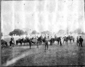[Photograph of fourteen men mounted on horses]