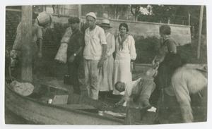 Primary view of object titled '[Photograph of a Group Preparing a Small Canoe]'.