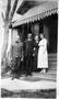 Photograph: [Mary E. Molly George, Two men, and a woman standing on porch steps]