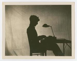 [Silhouette Of A Boy Typing At A Desk]