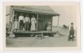 Photograph: [Four People Stand Outside Their Home]