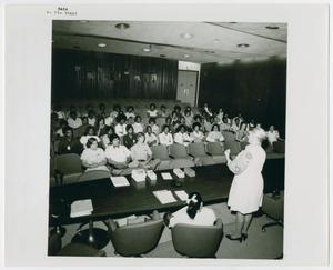 [A Woman Speaks to a Classroom of Students]