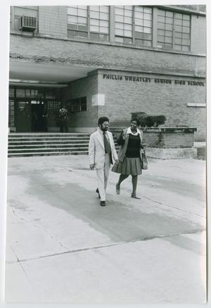 Primary view of object titled '[Barbara Jordan Walking Outside Her Old High School]'.
