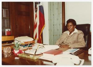Primary view of object titled '[Barbara Jordan Sitting at Her Desk]'.