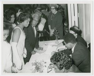 Primary view of object titled '[Muhammad Ali Signs Autographs]'.