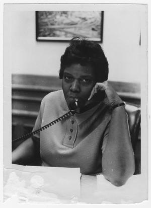 Primary view of object titled '[Barbara Jordan Answers a Phone at Her Desk]'.