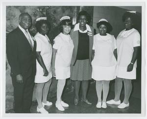 Primary view of object titled '[Barbara Jordan with Staff of Houston Veterans Administration Hospital]'.