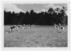Primary view of object titled '[A Group of Boys Stretch in a Field]'.