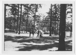 Primary view of object titled '[Three Persons Walk on a Volleyball Court]'.