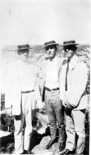 [Albert P. George and two other men standing on a cliff]