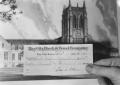Photograph: [Donation Check Being Held up to an Artist's Rendering of Shelton Cha…