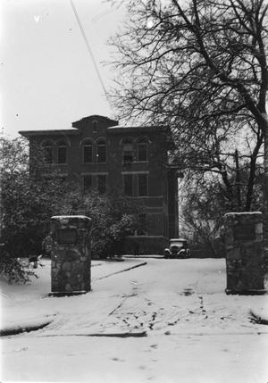 [Large Building with Driveway Covered in Snow]