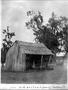 Photograph: [Wooden shack with front side completely missing]