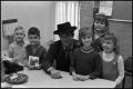 Photograph: [Robert Conrad Sitting With Children Surrounding Him]
