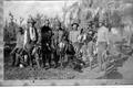 Photograph: [Photograph of seven men in a row following a hunt]