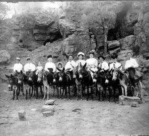 [Photograph of eleven individuals on mule]