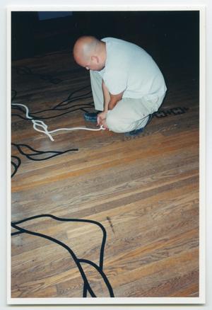 [Photograph of a Man Tracing an Outline of Floor Art]
