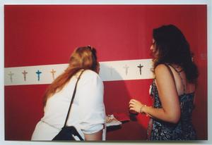 [Photograph of Two Women Looking at Art on an Exhibit Wall]