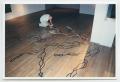 Photograph: [Photograph of a Man Tracing an Outline of Floor Art]