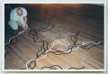Photograph: [Photograph of a Man Tracing Floor Art]