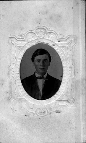 [A young man wearing a dark suit, vest, bow tie and a white collared shirt]