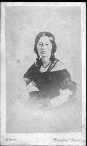 Primary view of object titled '[An unidentified woman sitting in a chair with her hands resting in her lap]'.