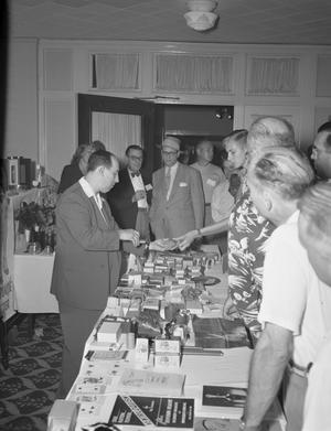 Primary view of object titled '[People at a Vendor at a Texas Association of Magicians Conference]'.