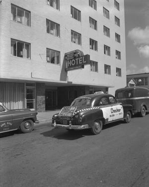 Primary view of object titled '[Yellow Checker Cab with a KTXN Advertisement at Commodore Perry Hotel]'.