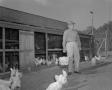 Primary view of [Man Holding Basket of Eggs with Chickens]