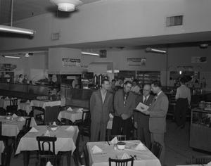 [Four Men Reading a Menu at the Texan Café]