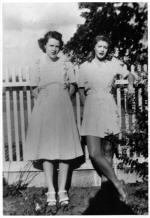 [Mary Jones Prowell and Helen Jane Farmer standing against a fence at George Ranch]