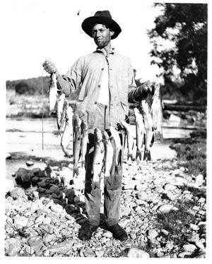 Primary view of object titled '[Photograph of Taylor with Stringer of Catfish]'.