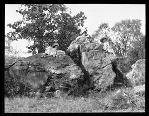 [Photograph of Girls Lounging on Large Rocks]