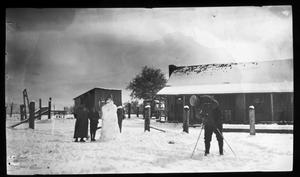 [Photograph of Family Taking Picture of Snowman]