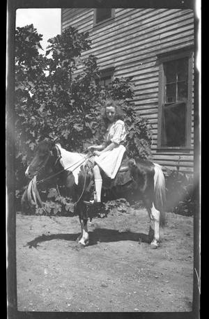 [Photograph of Girl Sitting on Pony]