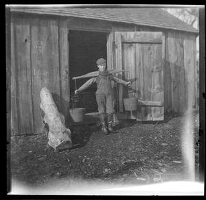 [Photograph of Young Man Carrying Buckets]